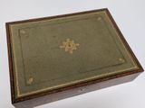 an old wooden box with a floral design on the lid