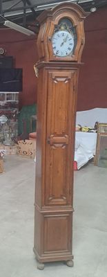 une grande horloge de parquet en bois au milieu d'une pièce