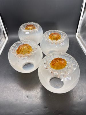 four clear bowls with oranges in them sitting on a counter