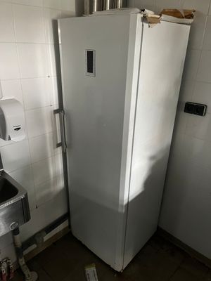 a white refrigerator in a kitchen next to a sink