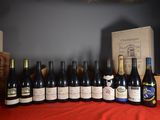 bottles of wine are lined up on a red table cloth