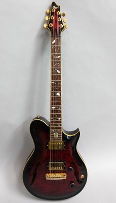 a close up of a guitar on a white surface with a white background