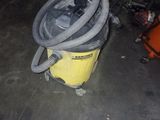 a yellow and black vacuum sitting on the floor