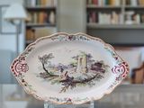a plate with a picture of a castle on it on a table