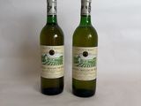 two bottles of wine sitting next to each other on a table