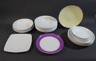 many plates and bowls sitting on a black table