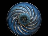 an image of a close up of a glass object on a black surface