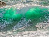 a man riding a surfboard on a wave in the ocean