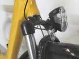 a close up of a yellow bicycle with a black handlebar