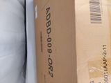 a cardboard box sitting on top of a pillow on a bed