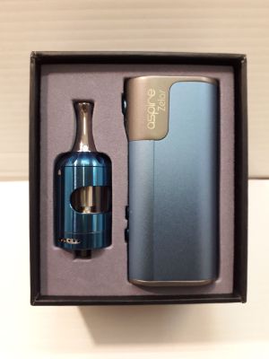 a bottle and a lighter in a box on a table