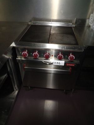 a silver stove top with two burners on it in a kitchen