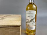 a bottle of wine sitting next to a wooden box