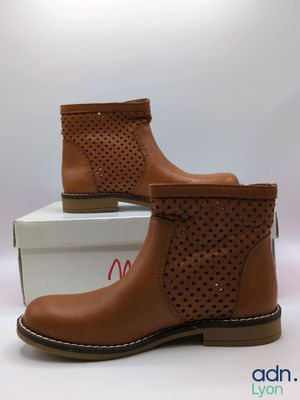 a close up of a pair of brown boots on top of a box