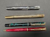 three different types of pens are lined up on a table