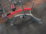 a red and gray exercise bench in a gym