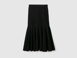 the skirt is black and has buttons on the front