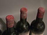 four bottles of wine are lined up in a row on a counter