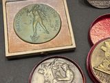 three different types of medals are on display in a box