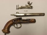 an old gun and other items on a white surface