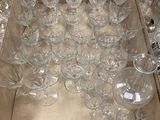 des bouteilles et des verres sont disposés sur un plateau posé par terre