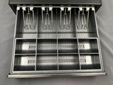 a metal tray with a bunch of utensils in it