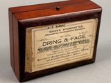 an old wooden box with a label on it sitting on a table