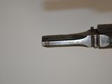 an old gun with a metal handle on a white surface
