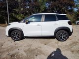 a white car that is parked in a parking lot