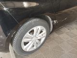 a picture of a car with a flat tire on the side of the road