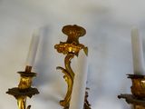 two candles that are on the wall next to each other