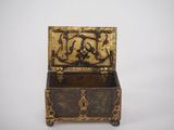 an antique brass box with a design on the lid