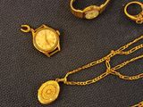 a lot of gold jewelry on a black surface