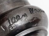a close up of a metal object with writing on it