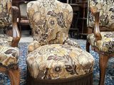 three chairs that are sitting on a rug in a room