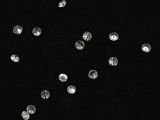 black background with a lot of diamonds falling from the sky