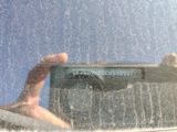 reflection of a person in a car window with a cat on the windshield