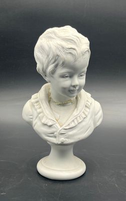 porcelain bust of a boy with a collared shirt on a pedestal