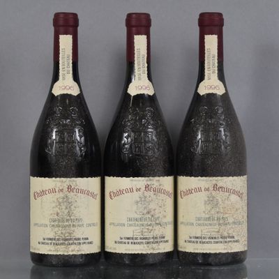 three bottles of red wine are lined up on a table