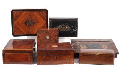 several wooden boxes are lined up on a white surface