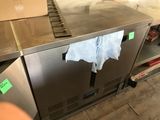 a stainless steel counter with a towel hanging on it