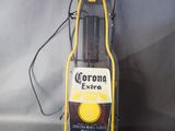 a close up of a beer bottle on a stand with a cord