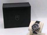 a close up of a watch in a box on a white surface