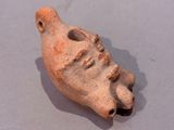 a small clay object with a face on it