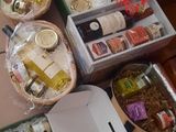 several boxes of food are sitting on a table with other food items