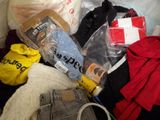 a pile of clothes and other items in a trash can