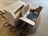 a laptop sitting inside of a box on a pallet