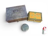 a small wooden box with a stone in it