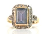 an image of a ring with a blue stone in it