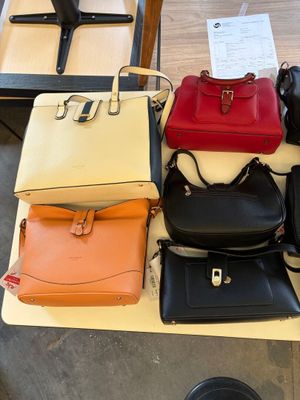 a lot of purses that are on a table
